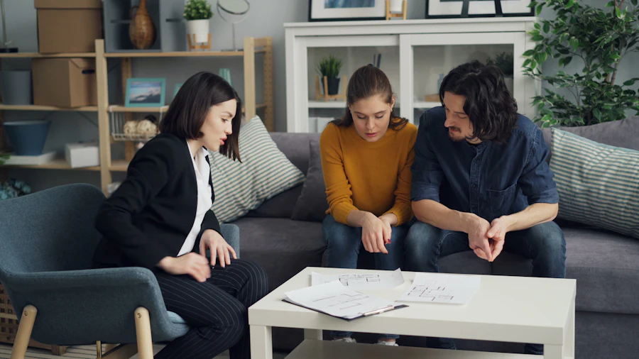 Consultora conversando com um casal no sofá